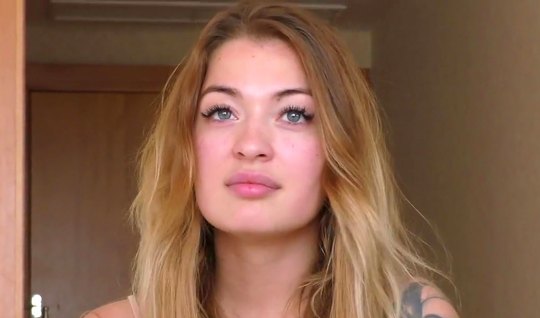 Slim girl at the casting undresses and shows tattoos on an appetizing body